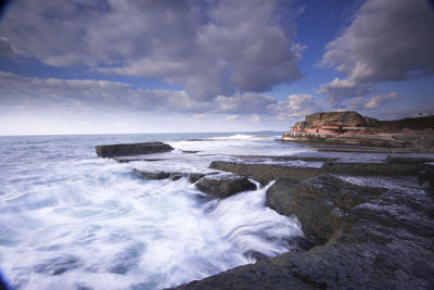 Scenic view of sea against cloudy sky