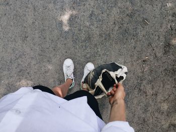 Low section of person standing on tiled floor