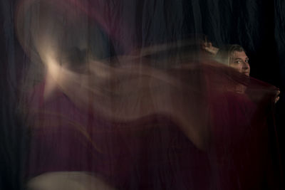 Time lapse view of woman moving a rag. long exposure, motion blur.