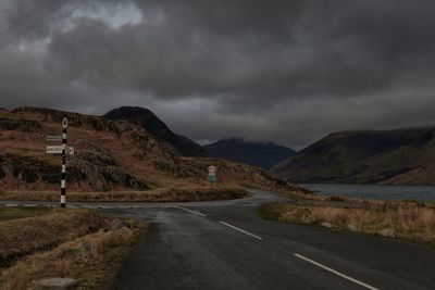 Road amidst mountains against sky