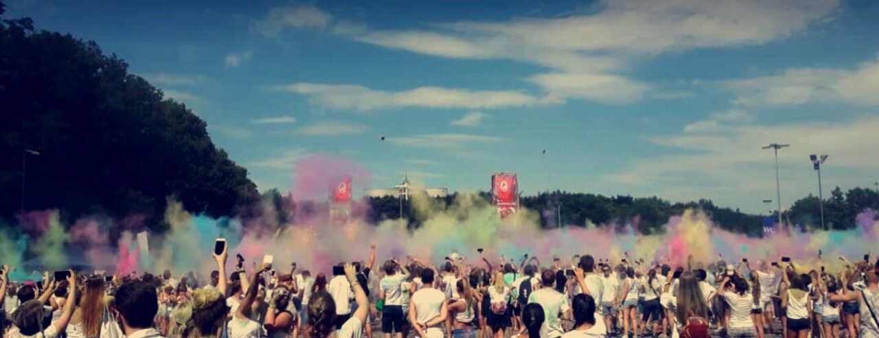 large group of people, crowd, fun, men, celebration, enjoyment, people, togetherness, adult, cloud - sky, holi, excitement, multi colored, outdoors, adults only, sky, women, day, real people, happiness, powder paint, popular music concert, only men