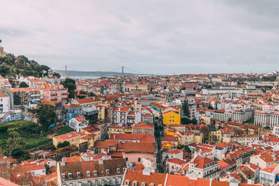 View of cityscape against cloudy sky