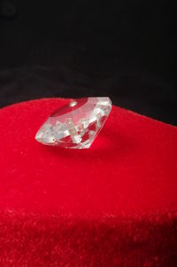 Close-up of ring on table against black background