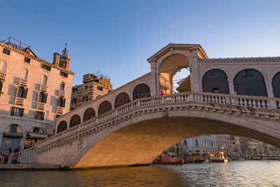 Arch bridge over river in city