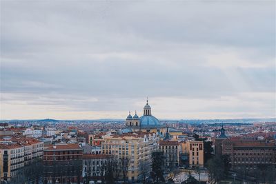 High angle view of buildings in town against sky