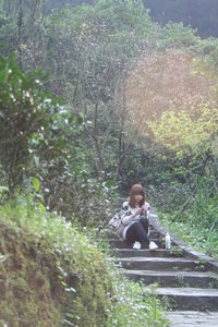 Woman sitting in a forest