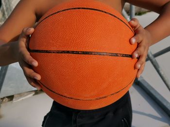 Close-up of man holding ball