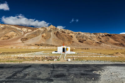 Scenic view of snowcapped mountains against blue sky