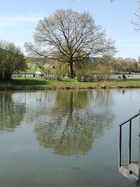 Scenic view of lake by trees against sky