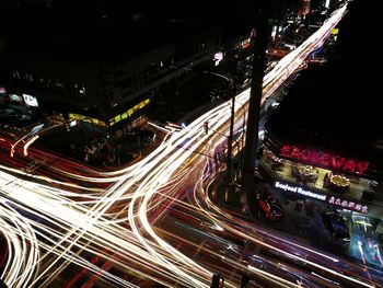 High angle view of light trails on highway in city at night