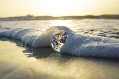 Close-up of water splashing on shore