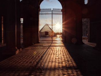 Metallic gate of building during sunset