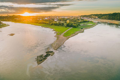 Scenic view of land against sky during sunset