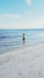 Man standing on beach against sky