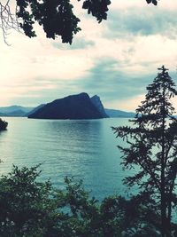 Scenic view of sea and mountains against sky