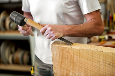 Midsection of carpenter working on table