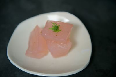 Close-up of gelatin dessert garnished with flower in plate on table