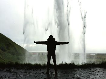 Silhouette of man in water