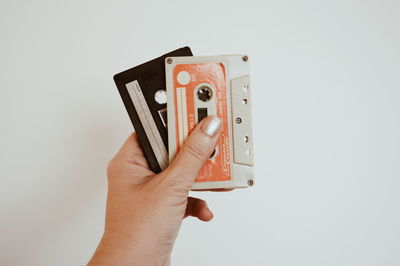 Close-up of person photographing against white background