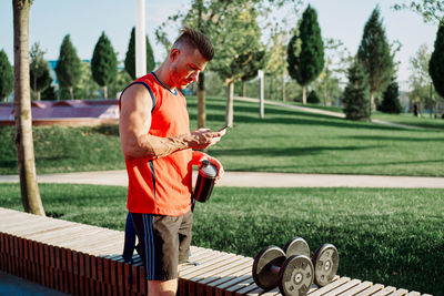 Man using mobile phone at park