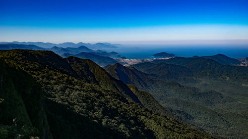 Scenic view of mountains against blue sky