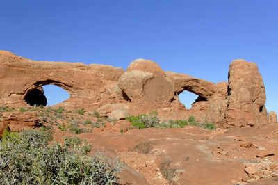 Rock formations against clear blue sky