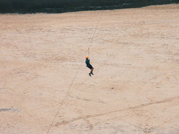 Man zip lining over the lake