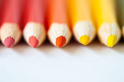Close-up of colored pencils on white background