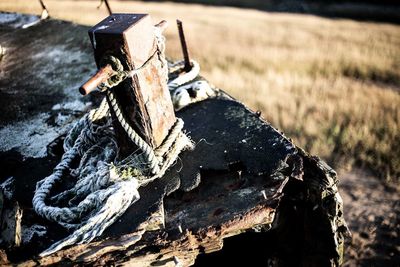 Close-up of old rusty wheel on field