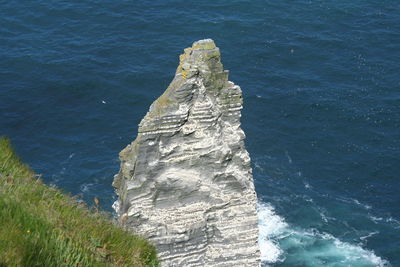 High angle view of stack rock against sea