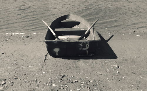 Boat moored on shore at beach