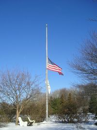 Low angle view of american flag against blue sky