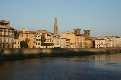 Buildings in city against clear sky