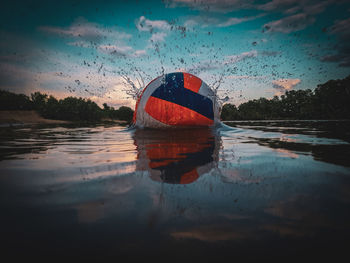 Abandoned boat in sea against sky