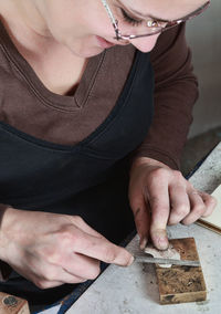 Woman making jewelry in workshop