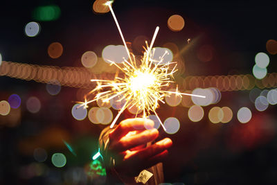 Close-up of hand holding illuminated sparkler