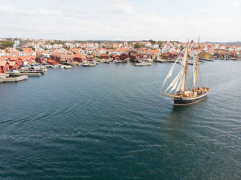 High angle view of townscape by sea against sky