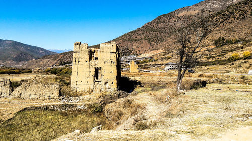 View of old ruin on mountain against sky