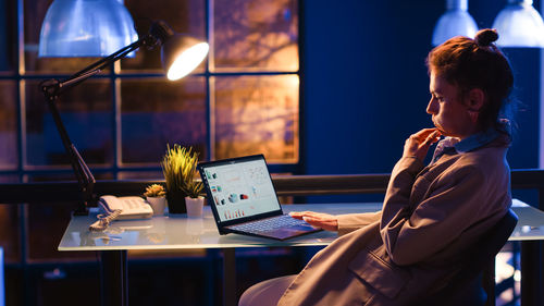 Young woman using laptop at table