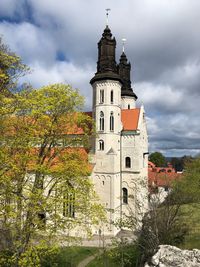 Low angle view of trees and church against sky