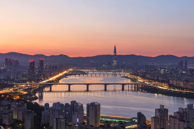 City at waterfront during sunset