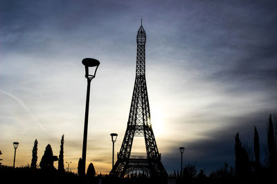 Low angle view of silhouette replica eiffel tower against sky during sunset