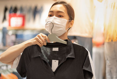 Woman trying t-shirt in store