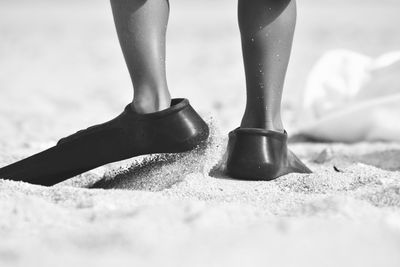 Low section of woman standing on tiled floor