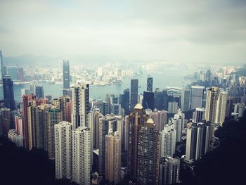 Aerial view of city against cloudy sky