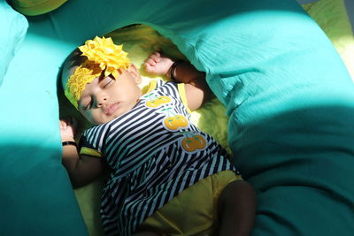 High angle view of cute baby boy sleeping on bed