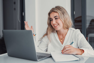 Young woman using laptop at home