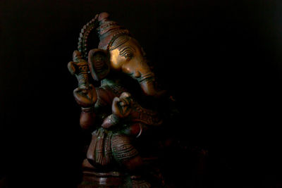 Close-up of statue against black background