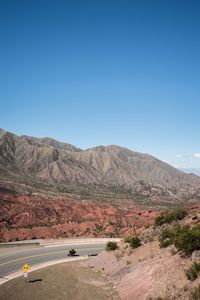 Scenic view of mountains against clear blue sky