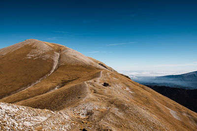 Scenic view of mountain against blue sky in arquata del tronto, marche italy 